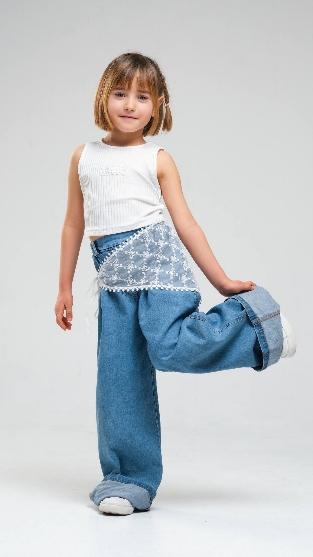 Wide-leg denim jeans with lace belt by NOV7, featuring classic blue denim and stylish wide-leg cut.