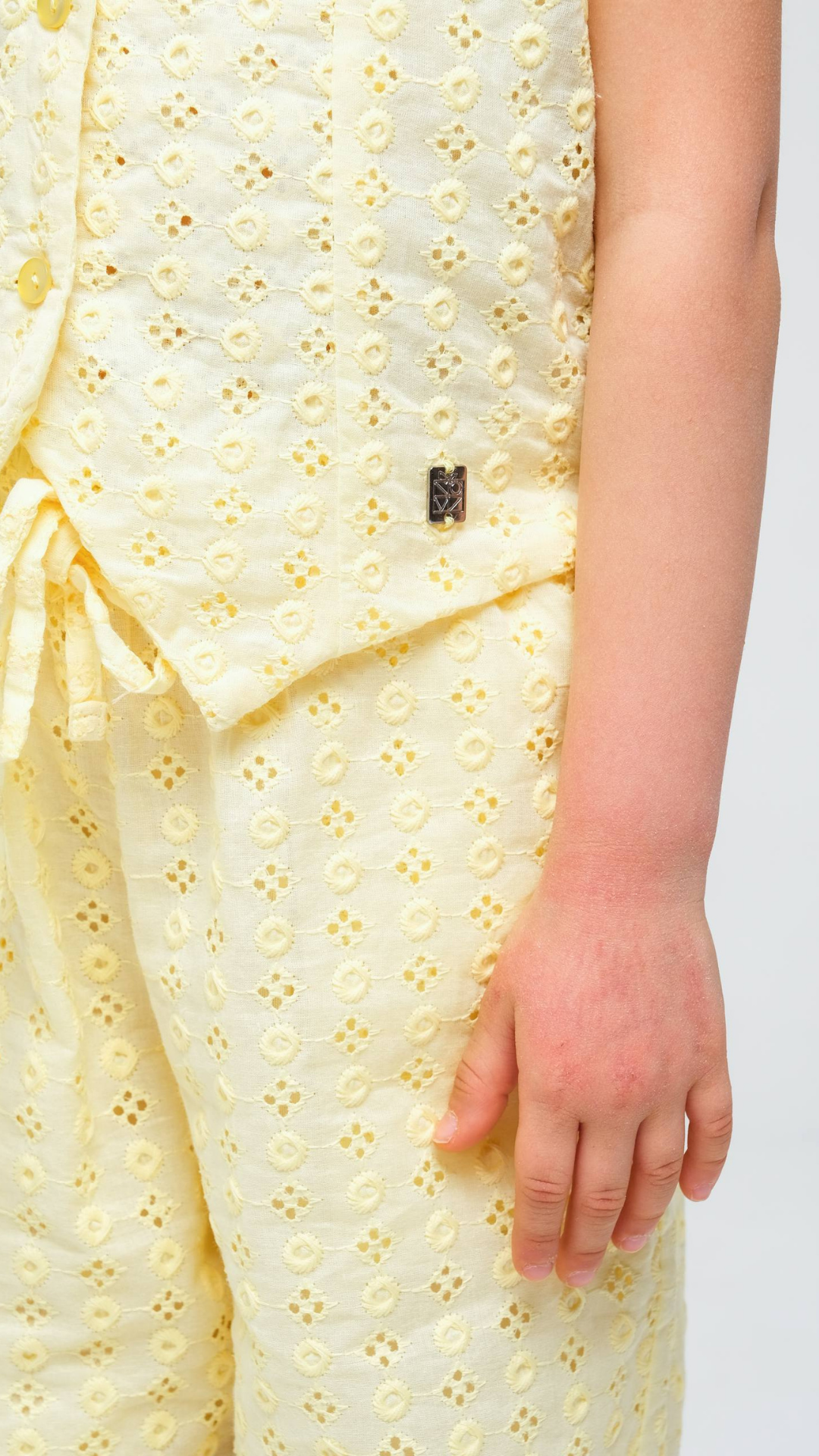 NOV7 Blossom Eyelet Two-Piece Set featuring a floral eyelet top and matching skirt, styled for a chic, feminine look.