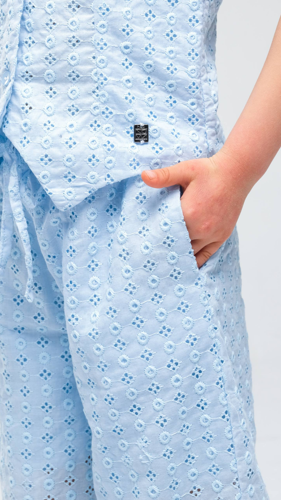 NOV7 Blossom Eyelet two-piece set featuring floral patterned fabric and eyelet detailing on top and matching skirt.