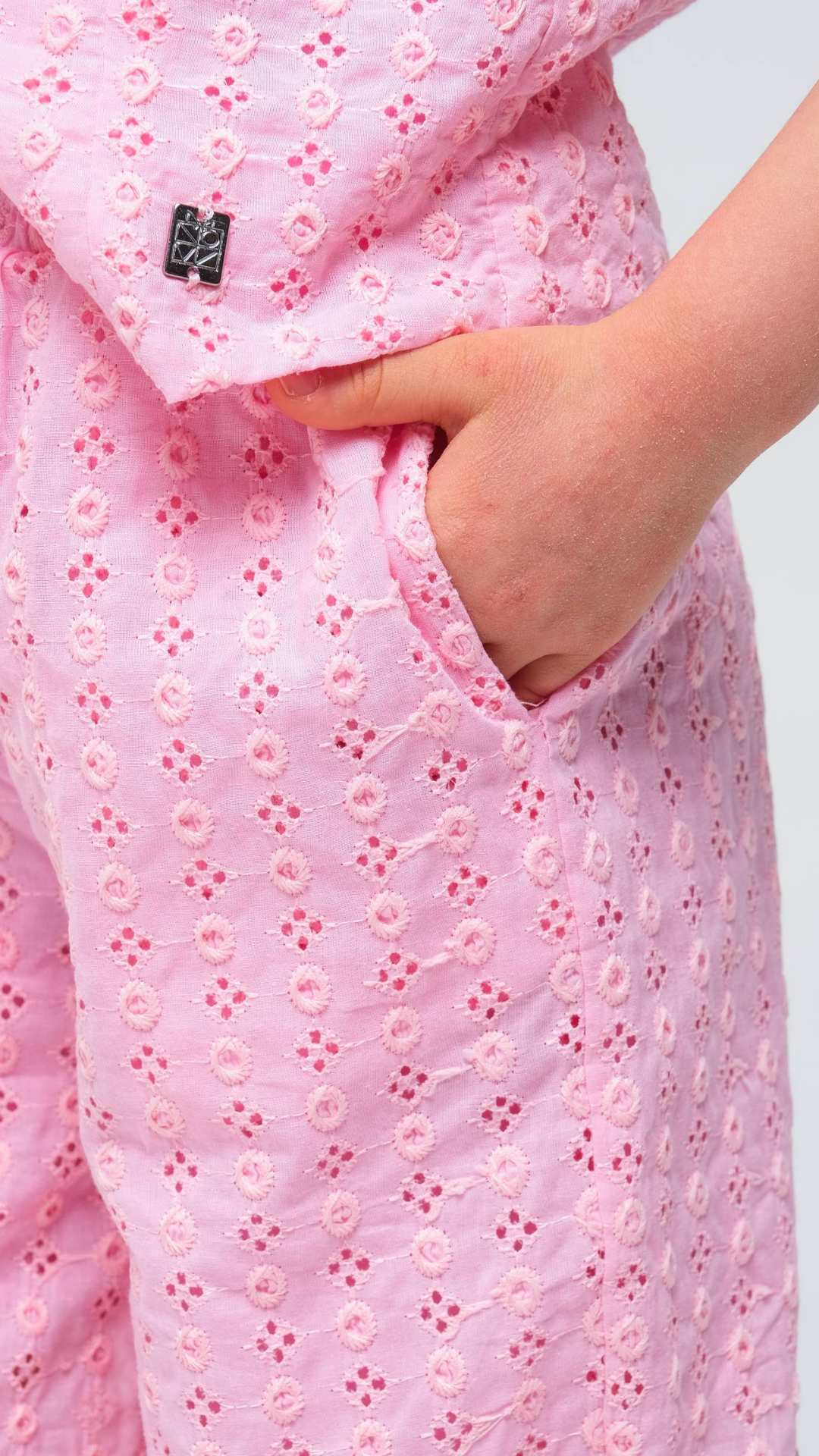 Black Blossom Eyelet Two-Piece Set by NOV7 featuring eyelet details and a stylish, coordinated top and bottom ensemble.