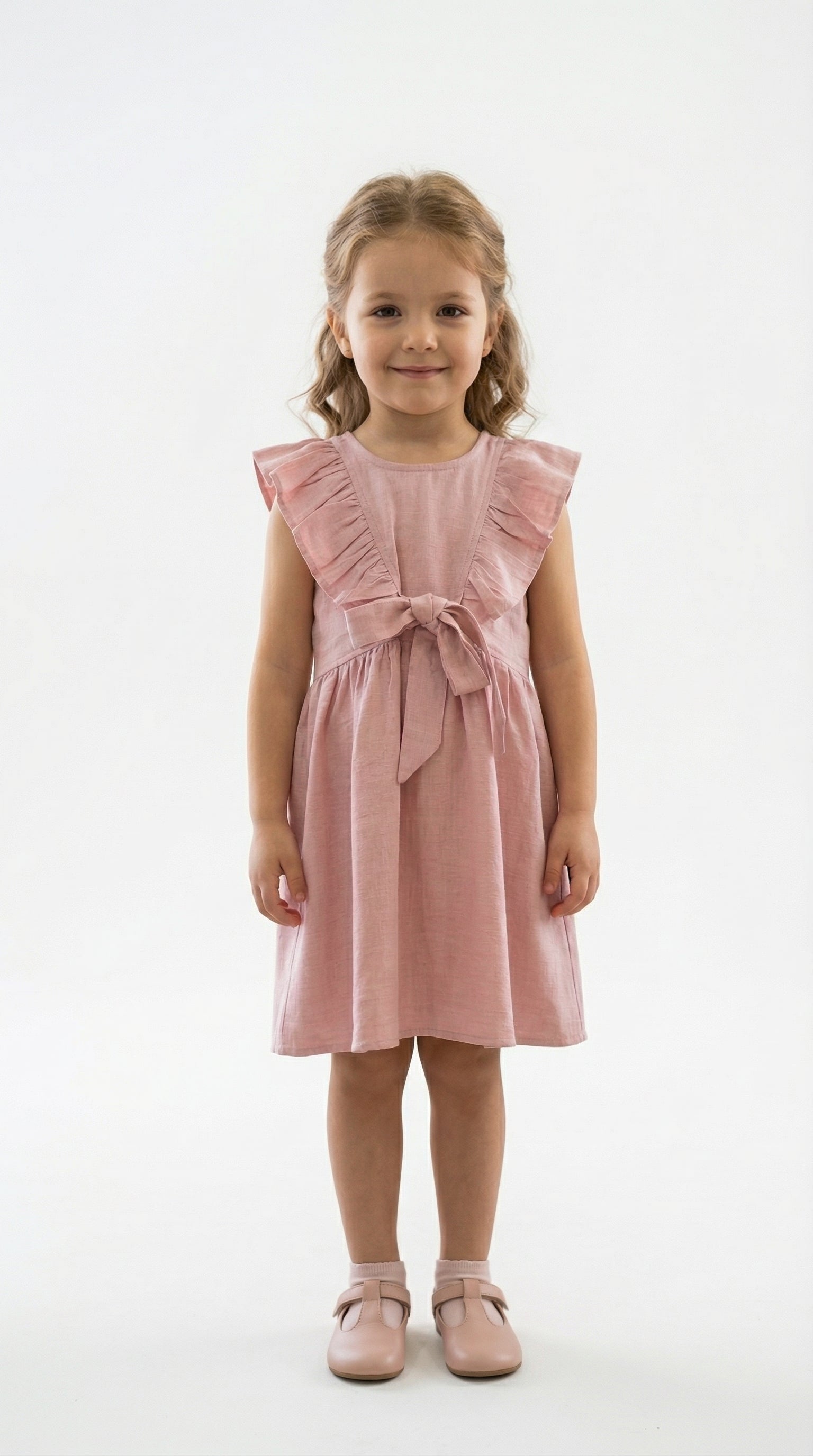 Young girl wearing a pink dress with ruffled sleeves on a white background