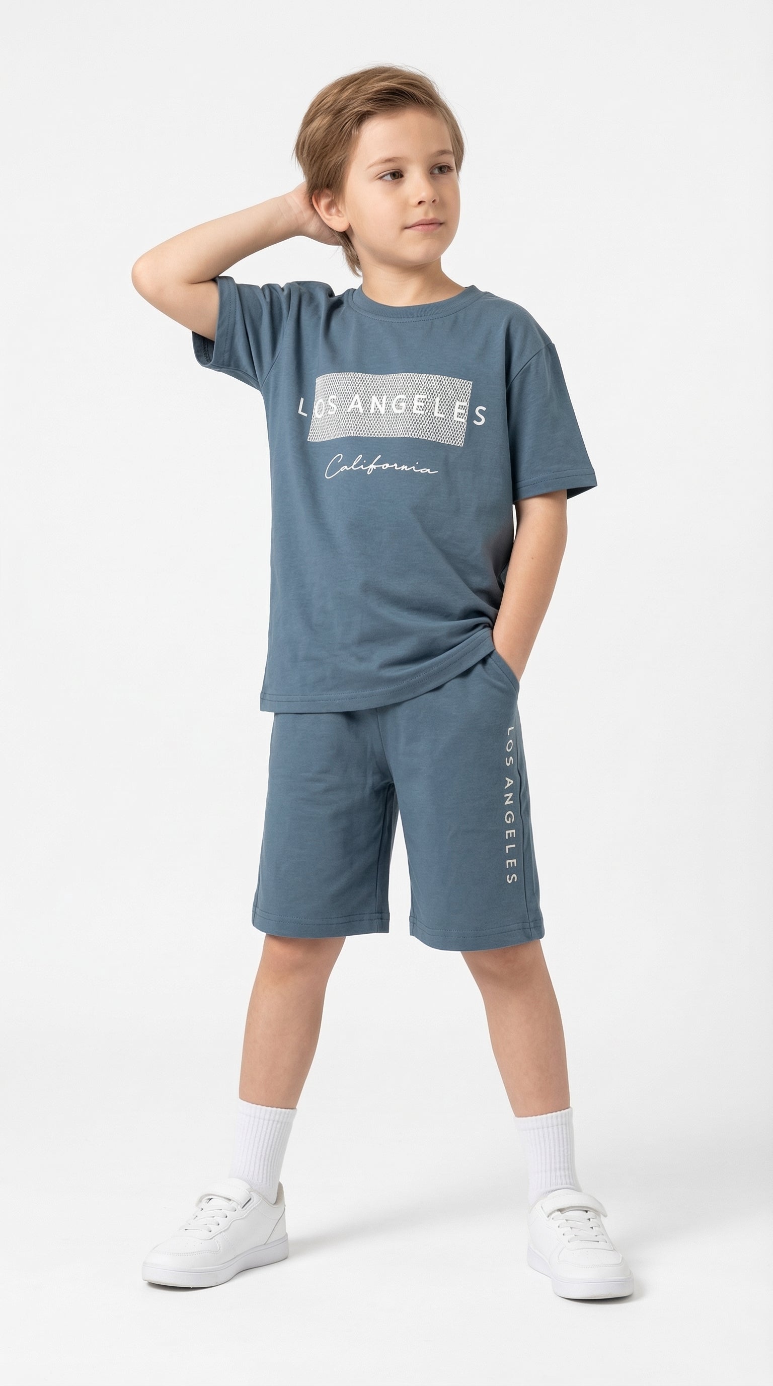 Kids wearing the California Coast set by Kocak Kids, featuring stylish and colorful summer clothing in a bright studio setting.