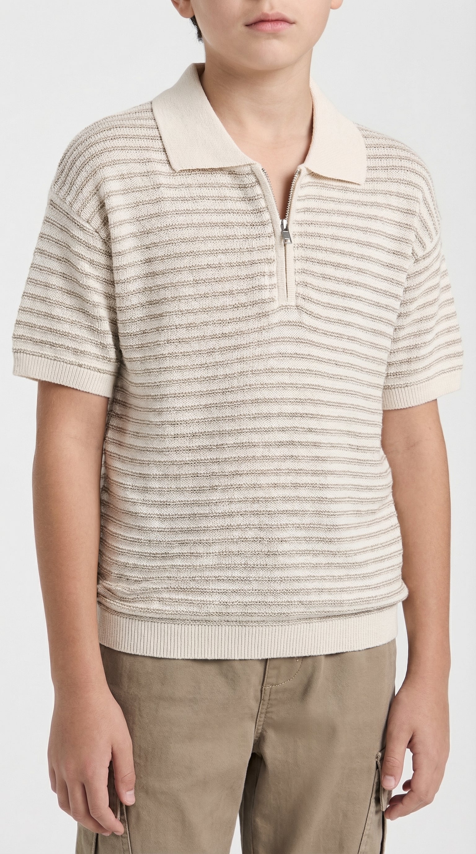 Children's beige textured zip polo shirt by Escable Kids, showing the front view with collar and zipper detail.