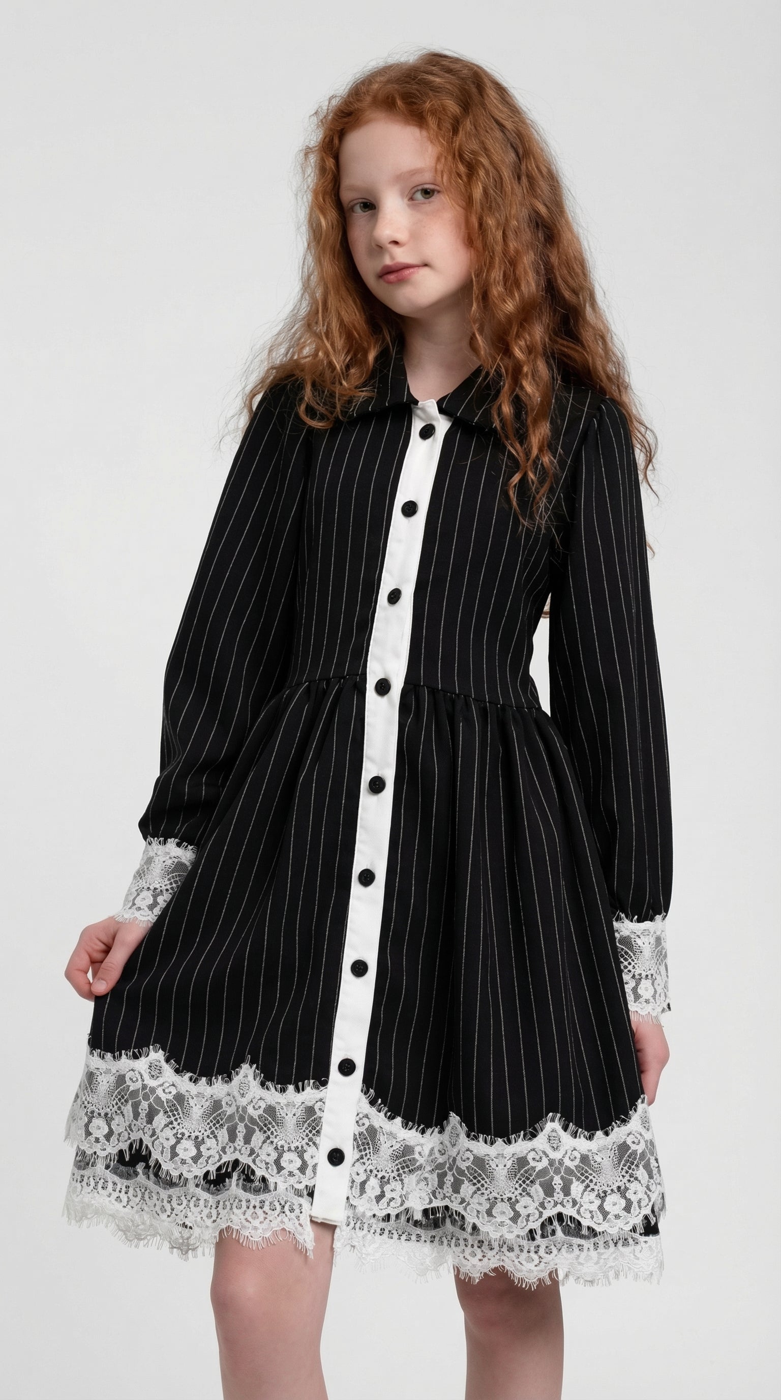 Child wearing a midnight pinstripe lace dress by Escable Kids, showcasing a stylish, elegant children's fashion dress with lace details.