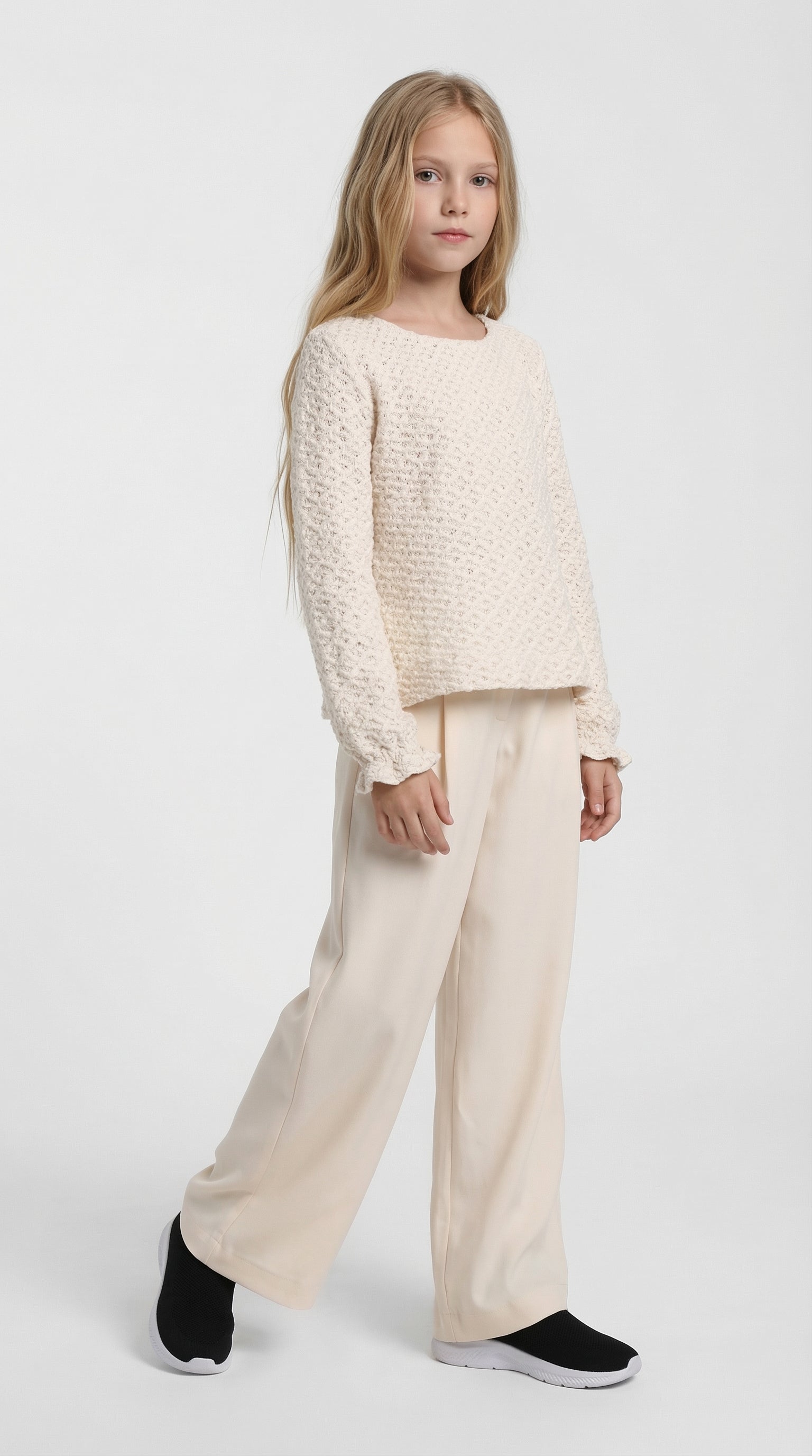 Child wearing ivory Breeze knit set by Escable Kids, featuring a cozy knit top and matching pants for stylish comfort.