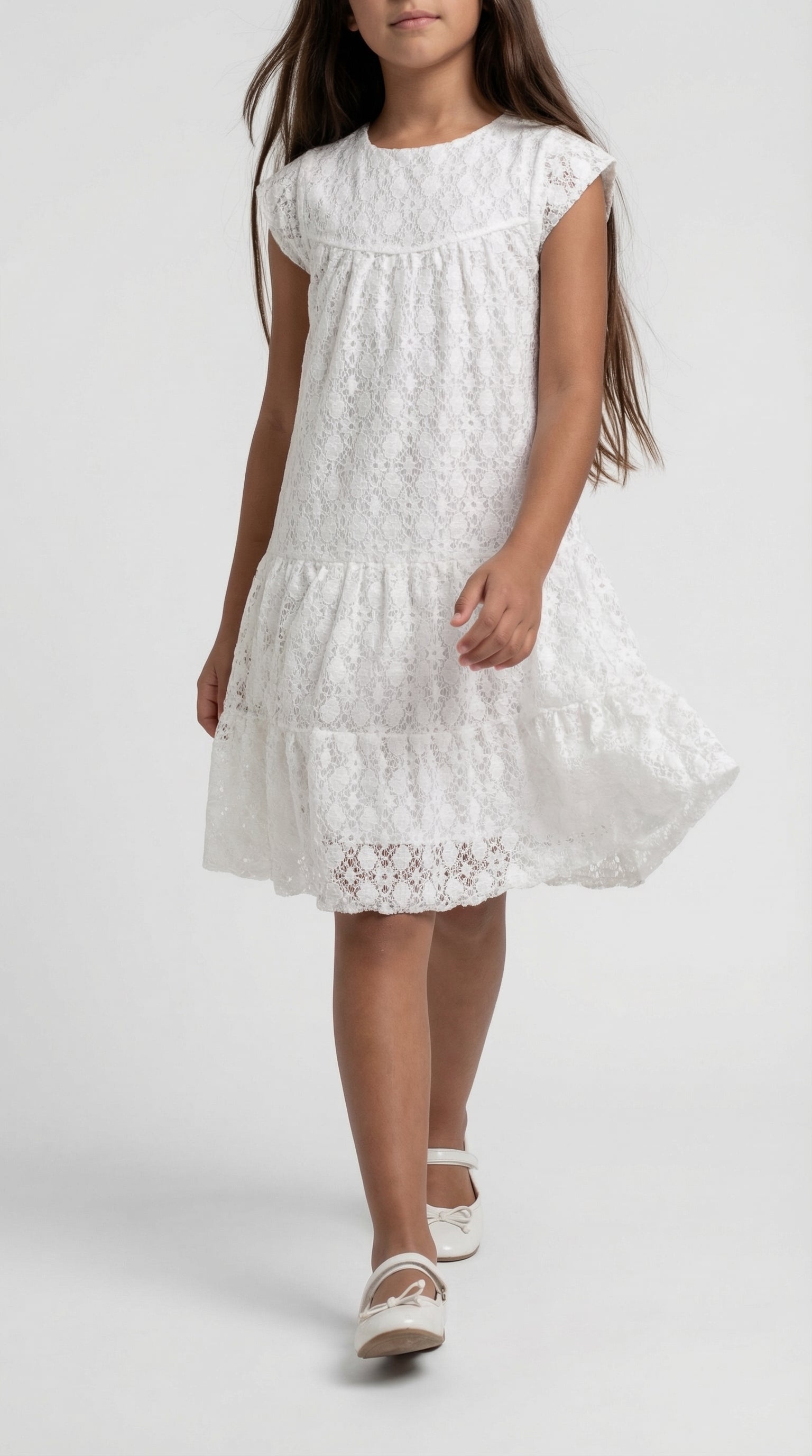 Child wearing a white pearl lace tier dress by Escable Kids, featuring layered lace fabric and a classic, elegant design.